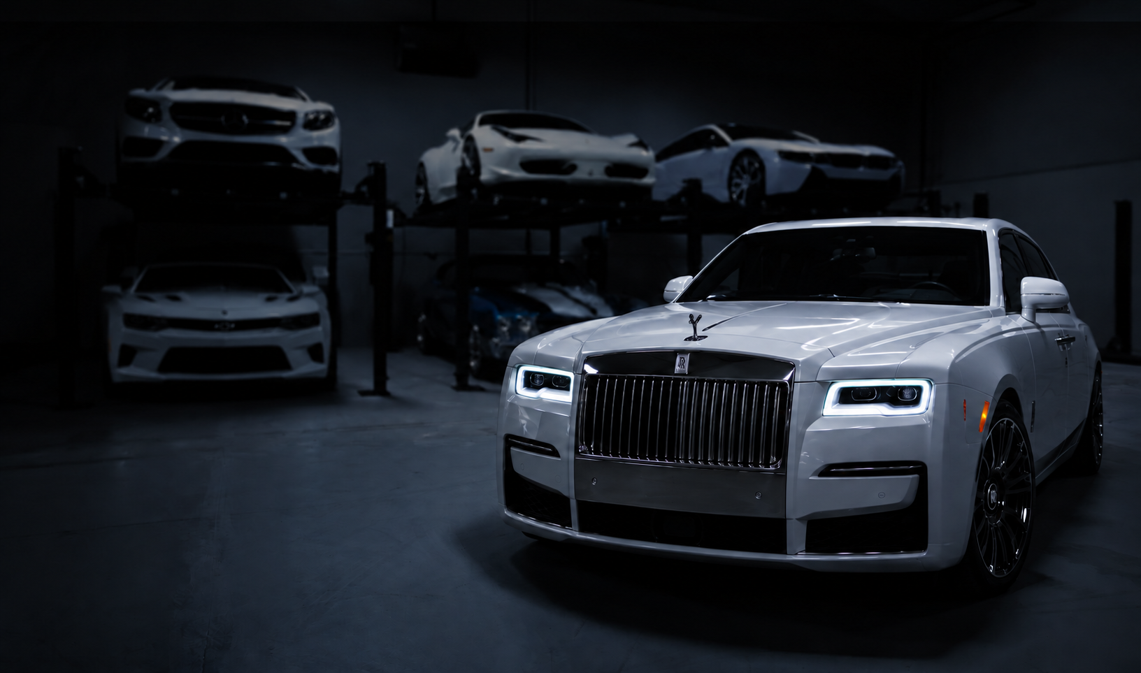 White Rolls-Royce in a dark automotive showroom